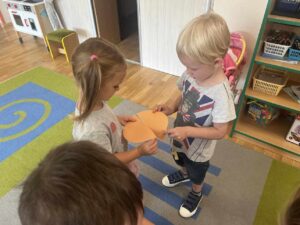ZUCHY - Dwoje dzieci dopasowuje części koła z papieru